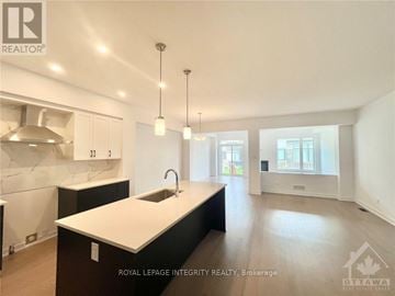 Ottawa townhouse for rent - A modern kitchen with a sink and cabinets.