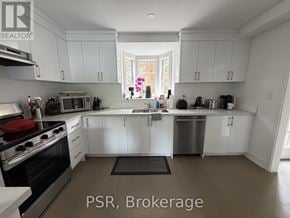 Toronto (Lawrence Park South) apartment for rent - A kitchen with white cabinets and stainless steel appliances.