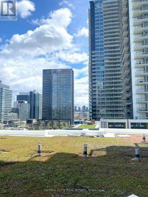 Toronto (Bayview Village) condo for rent - A cityscape with a large building in the foreground and smaller buildings in the background.