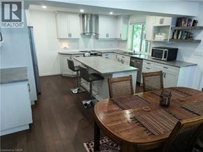 Kitchener apartment for rent - A kitchen with a table and chairs in the middle of it.