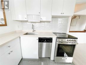 Toronto (Danforth Village-East York) apartment for rent - A white kitchen with a stainless steel dishwasher and oven.