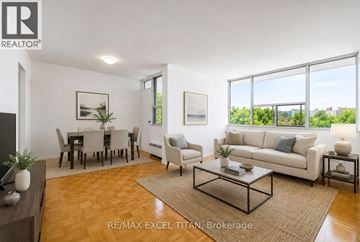 Toronto (Bendale) condo for rent - A well-lit living room with a dining table and chairs.