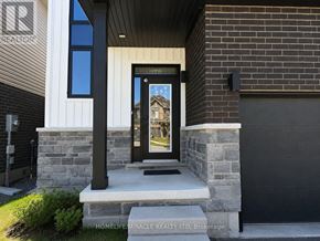 Brantford apartment for rent - A modern house entrance with a glass door and a picture of a house on the glass.