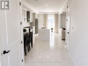 Brantford apartment for rent - A white kitchen with a black handle door.