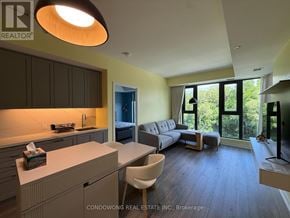 Toronto (Lawrence Park North) condo for rent - A well-lit kitchen with a dining table and chairs.