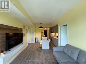 Toronto (Lawrence Park North) condo for rent - A living room with a grey couch and a television.
