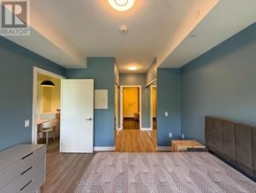 Toronto (Lawrence Park North) condo for rent - A bedroom with a bed, dresser, and mirror.