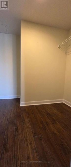 Toronto (Lansing-Westgate) condo for rent - A room with wooden flooring and white walls.