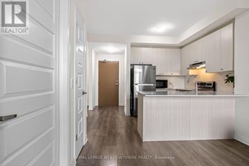 Milton (Fo Ford) condo for rent - A kitchen with white cabinets and a wooden floor.