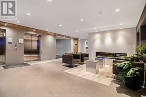 Milton (Fo Ford) condo for rent - A modern office lobby with a reception desk and a potted plant.
