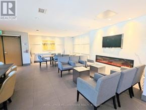 Milton (Fo Ford) condo for rent - A living room with a fireplace and a television.