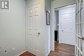 Toronto (Islington-City Centre West) condo for rent - A white door with a gold handle is in a room with a white wall and a wooden floor.