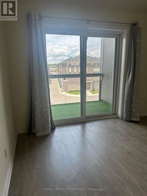 Brampton (Credit Valley) condo for rent - A room with a sliding glass door leading to a balcony.