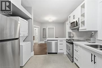 Hamilton apartment for rent - A modern kitchen with white cabinets and stainless steel appliances.