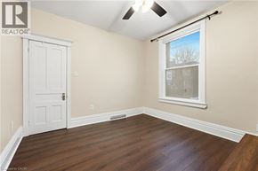 Hamilton apartment for rent - A room with a white door and a window with a view of trees outside.