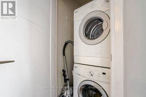 Toronto (Willowdale East) condo for rent - A white washing machine is installed in a wall.