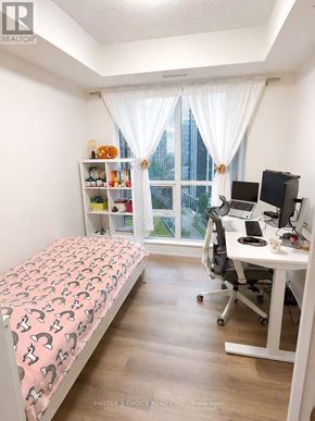 Toronto (Willowdale East) condo for rent - A bedroom with a bed, desk, and chair.