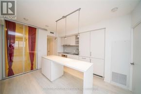 Toronto (Waterfront Communities) condo for rent - A modern kitchen with white cabinets and a central island.