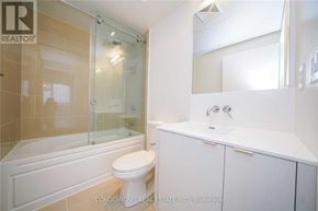 Toronto (Waterfront Communities) condo for rent - A white bathroom with a toilet, sink and shower.