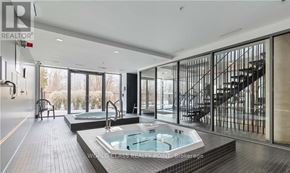 Burlington (Orchard) condo for rent - A modern bathroom with a hot tub and a staircase.