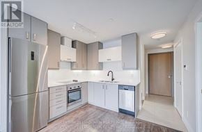 Markham (Unionville) condo for rent - A modern kitchen with stainless steel appliances and white cabinetry.