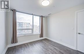 Markham (Unionville) condo for rent - A room with a large window and a view of a cityscape.