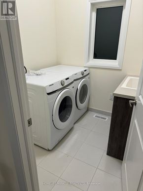 Springwater (Minesing) apartment for rent - A small laundry room with a washer and dryer.