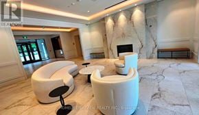 Toronto (Humber Heights) condo for rent - A living room with a white couch and a fireplace.