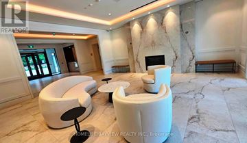 Toronto (Humber Heights) condo for rent - A living room with a white couch and a fireplace.