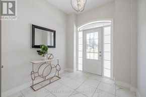 Vaughan (East Woodbridge) townhouse for rent - A room with a white door, a mirror, and a plant on a table.