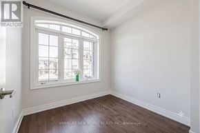 Vaughan (East Woodbridge) townhouse for rent - A room with a large window and a wooden floor.