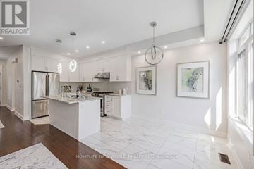 Vaughan (East Woodbridge) townhouse for rent - A well-lit, modern kitchen with white cabinets and a marble floor.