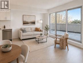 Toronto (Humber Heights) condo for rent - A well-lit, modern living room with a dining table and chairs, a sofa, and a large window.