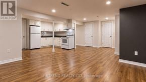 Toronto (Tam O'shanter-Sullivan) apartment for rent - A kitchen with white appliances and wooden floors.