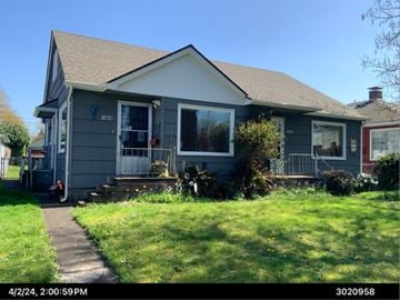 Longview apartment for rent - A house with a grey exterior and a small front yard.