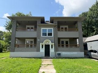 Louisville apartment for rent - A two-story house with a front yard and a car parked in the driveway.