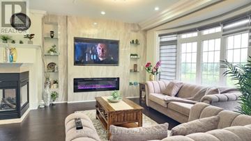 Brampton (Credit Valley) apartment for rent - A living room with a fireplace and a television on the wall.