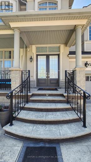 Brampton (Credit Valley) apartment for rent - A house entrance with a black gate and a plaque on the ground.