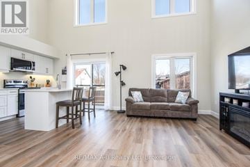 Stratford house for rent - A living room with a brown couch and a television.