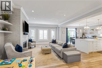 Waterloo apartment for rent - A living room with a grey couch and a wooden floor.