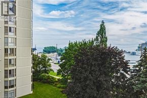 Burlington condo for rent - A tree in front of a building with the word REALTOR on it.