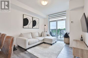 Hamilton (Waterdown) condo for rent - A living room with a white couch and a painting on the wall.