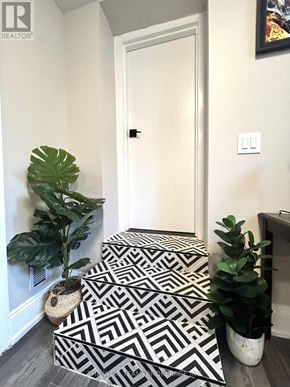 Toronto (East End-Danforth) apartment for rent - A hallway with a white door and a plant on the left.
