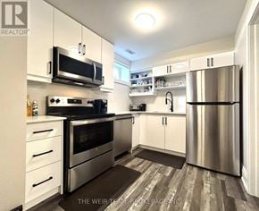 Toronto (East End-Danforth) apartment for rent - A modern kitchen with stainless steel appliances and white cabinets.