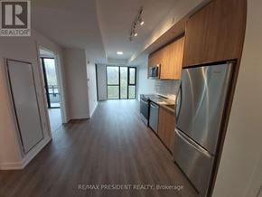 Milton (Cb Cobban) condo for rent - A kitchen with a refrigerator, oven, and microwave.