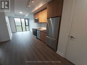 Milton (Cb Cobban) condo for rent - A modern kitchen with wooden cabinets and stainless steel appliances.