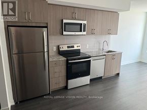Toronto (Humber Heights) condo for rent - A kitchen with a refrigerator, microwave, oven, and sink.
