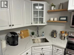 Hamilton apartment for rent - A kitchen with white cabinets and a marble countertop.