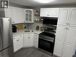 Hamilton apartment for rent - A kitchen with white cabinets and stainless steel appliances.