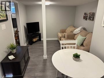 Hamilton apartment for rent - A living room with a white table and a couch.